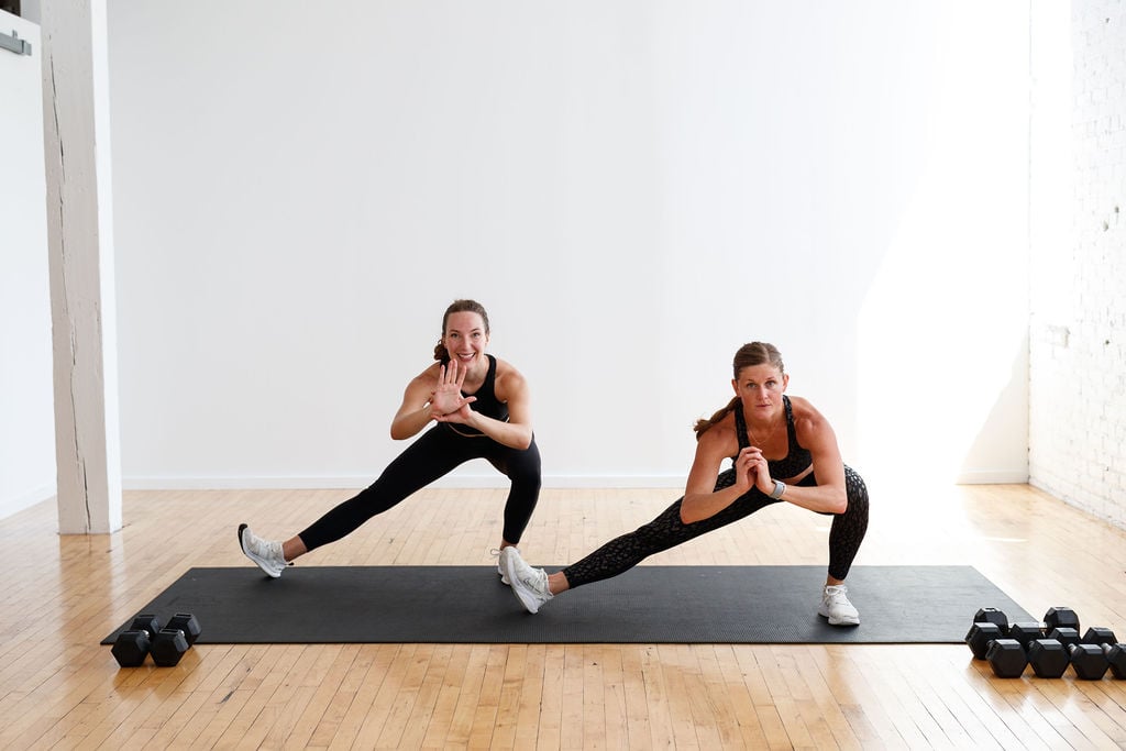 two women performing a cossack squat to improve hip mobility workout