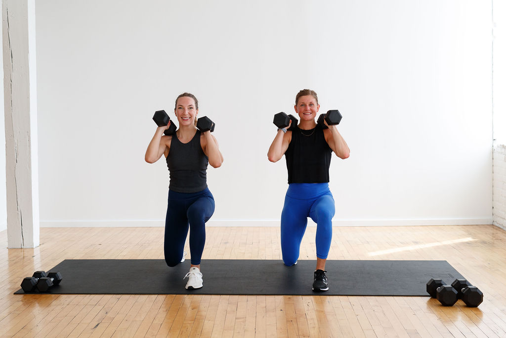 Two women performing a Lunge and Overhead Press | Total Body HIIT Workout