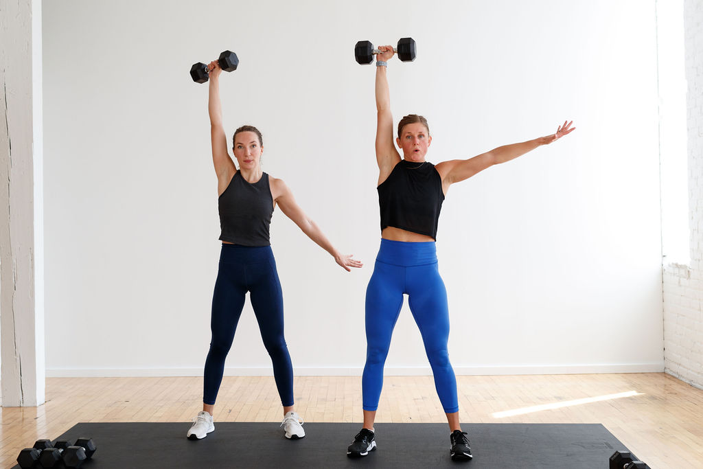 Two Women performing a Dumbbell Snatch as part of a Total Body HIIT Training At Home With Weights 
