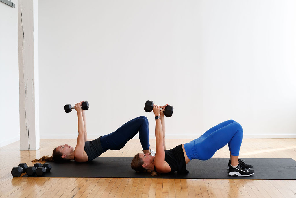 two women performing a glute bridge and tricep extension | total body hiit training