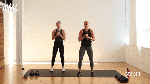 two women performing a 45 degree dumbbell press 