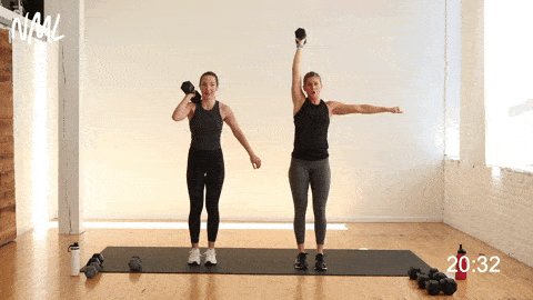 two women performing One Dumbbell Overhead Alternating Reverse Lunge 