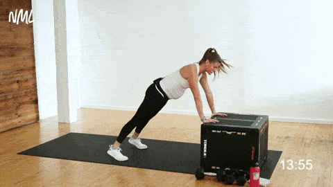 pregnant woman performing incline plank shoulder taps on a bench