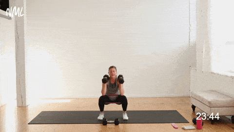 woman performing squat thrusters with weights