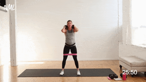 woman performing a back squat with weight in the best lower body exercises