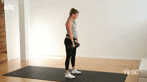 woman performing a deadlift and calf raise with dumbbells 