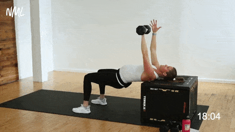 pregnant woman performing a single arm dumbbell chest press on an incline bench, prenatal arm workout