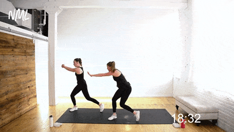 two women performing a lateral shuffle and chop; low impact cardio workout at home