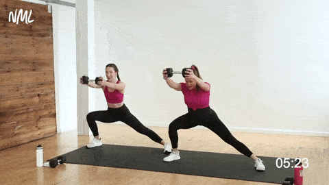 two women performing a lateral squat and dumbbell front raise