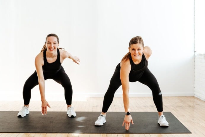 two women performing squat tap downs (low impact cardio workout)