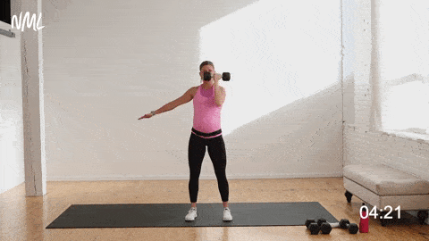 pregnant woman performing a single arm Arnold Press in a pregnancy workout with weights