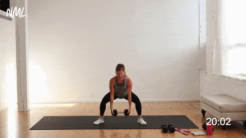 woman performing a sumo squat and clean squat