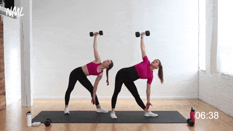 two women performing the windmill exercise with one dumbbell to strengthen the obliques 