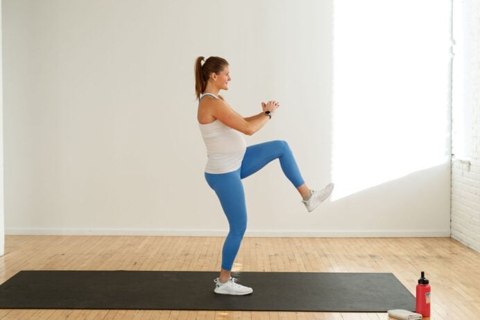 pregnant woman performing a knee drive in a 15 minute bodyweight prenatal workout