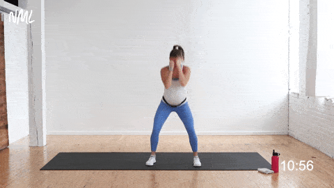 pregnant woman performing 2 jabs and 1 squat, low impact cardio pregnancy workout