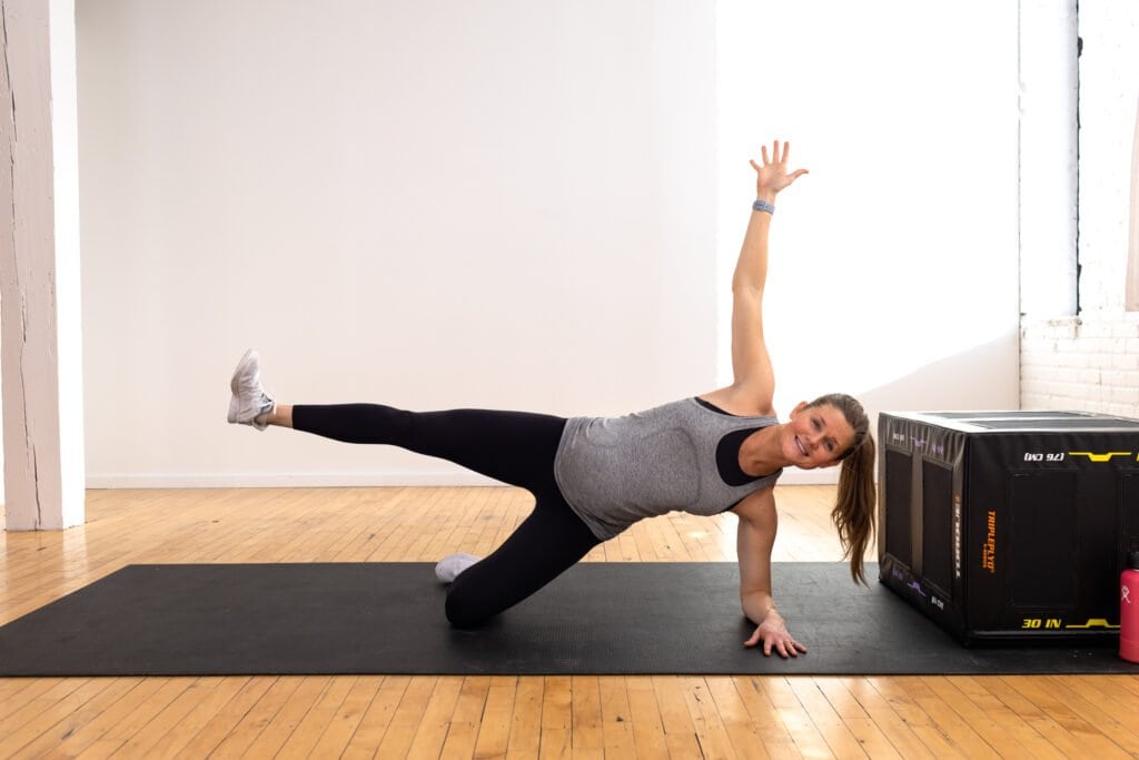 Pregnant woman performing a modified side plank or knee down side plank; pregnancy-safe ab exercises. 