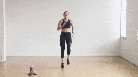 woman performing high knees in a no equipment HIIT cardio workout at home