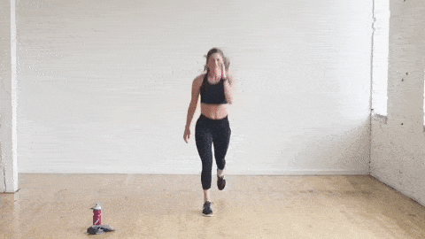 woman performing explosive lunge jumps as part of HIIT Cardio workout