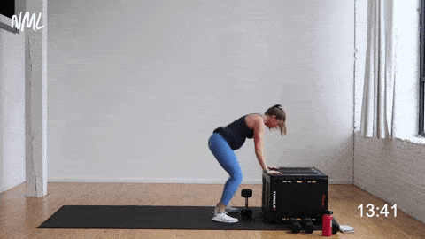 pregnant woman performing a supported burpee dumbbell back row 