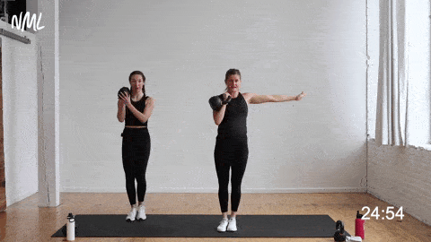 two women performing a kettlebell squat to kettlebell clean in a kettlebell leg workout
