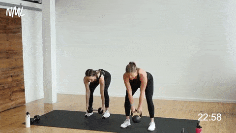 two women performing a kettlebell deadlift and clean and overhead press or front squat thrusters in a kettlebell leg workout for women