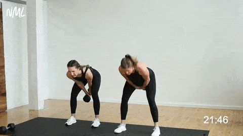 Two women performing kettlebell swings. One woman is using a kettlebell and one women is using a dumbbell for dumbbell swings (best kettlebell leg exercises)