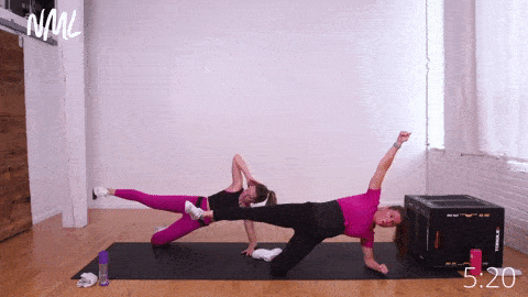 Two women performing 3 Side Plank Crunches and 3-Second Side Plank Hold