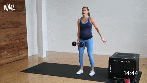 pregnant woman performing a single arm bicep curl and knee drive, prenatal workout