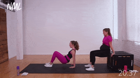 two women performing tricep dips from bench or ground