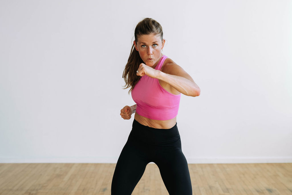 woman performing a crossbody punch as part of a no equipment workout