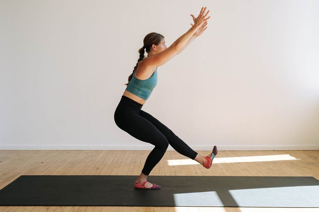 A bodyweight yoga workout with no equipment. Woman performing single leg chair yoga pose.