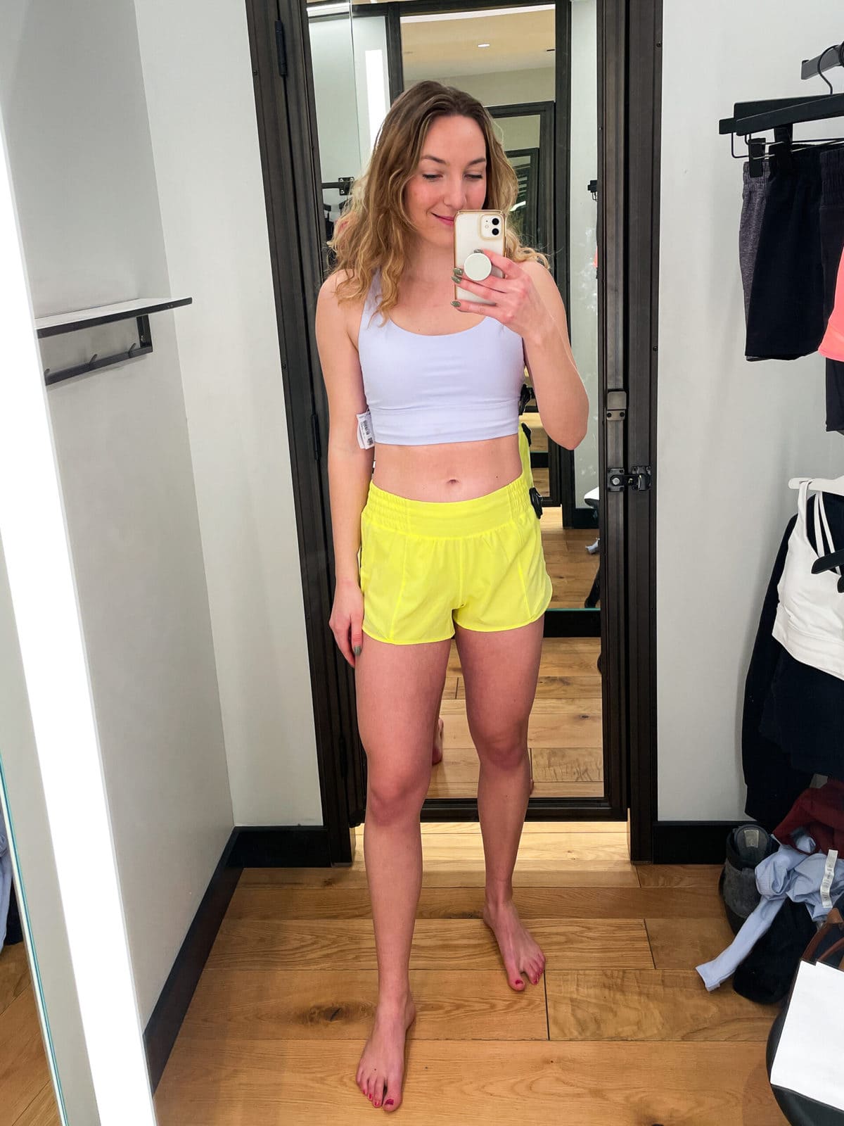 Rachel wearing Hotty Hot High Rise Short 2.5" in a dressing room mirror image