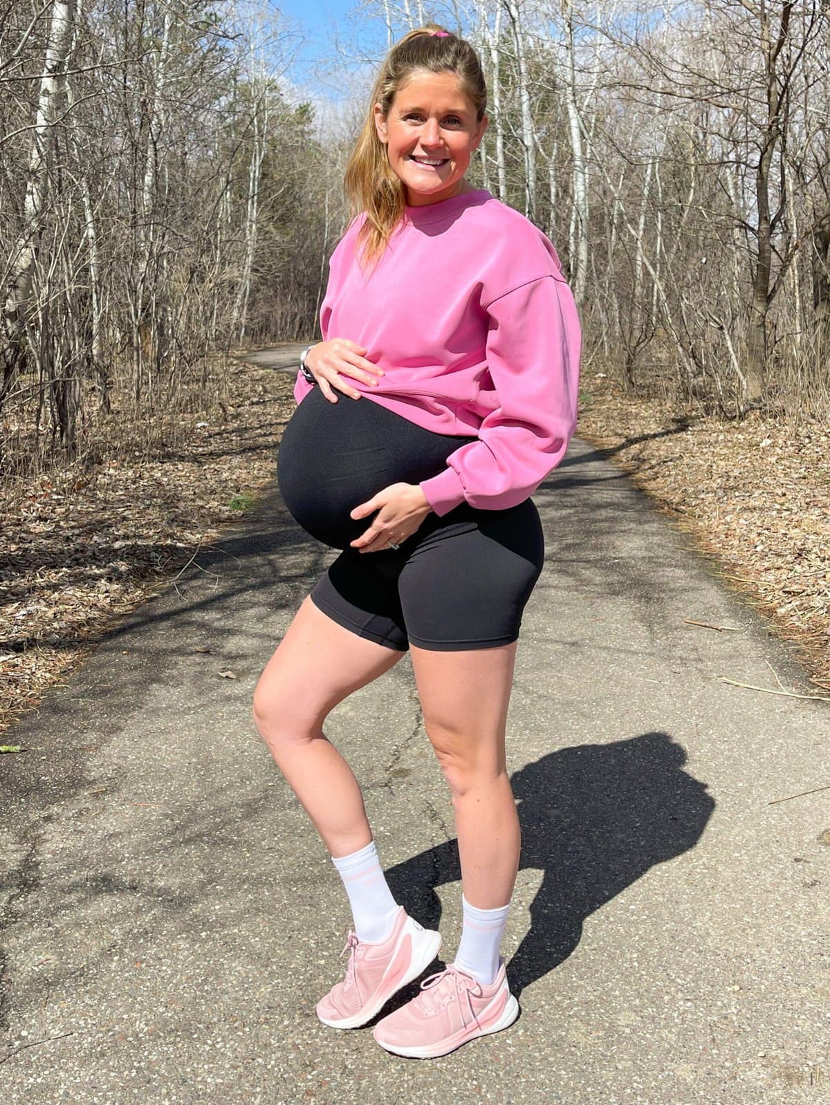 woman wearing pink blissfeel running shoes from lululemon on trail surrounded by woods