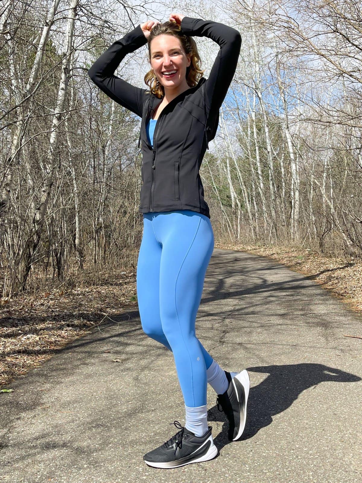 woman wearing blue base pace lululemon leggings and running shoes 