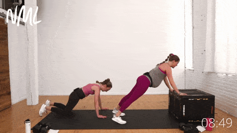 pregnant woman performing an incline push up to downward facing dog