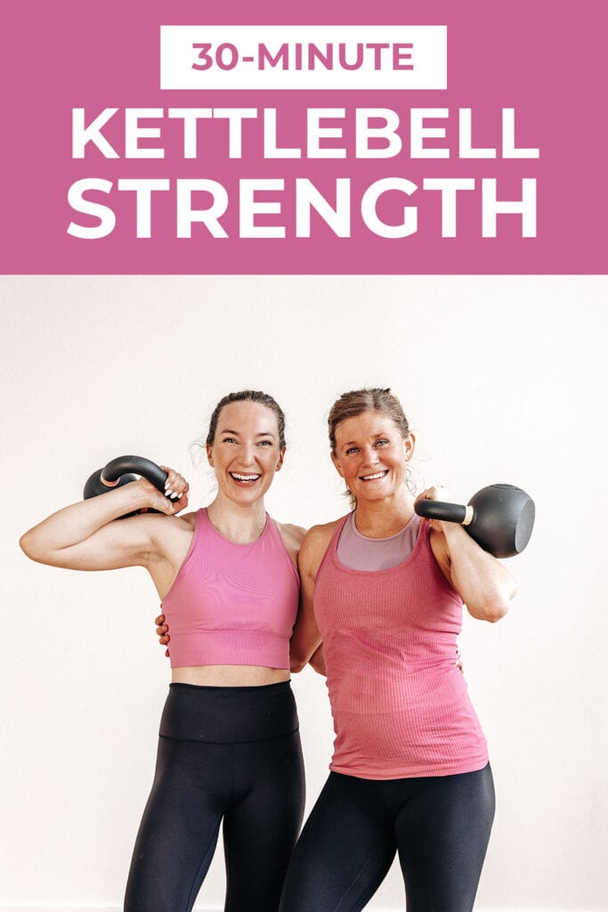 two women holding kettlebells in a clean position as part of a full body kettlebell workout at home