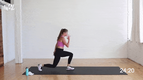 woman performing pass through lunges or a reverse lunge into a front lunge