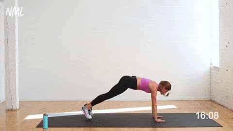 woman performing two high plank jacks to two standing jumping jacks