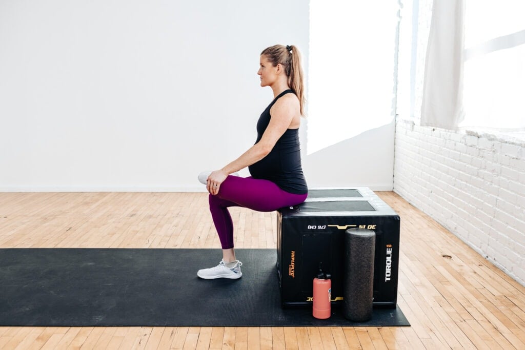 Woman performing a Seated Piriformoris stretch as part of exercises to relieve pain during pregnancy