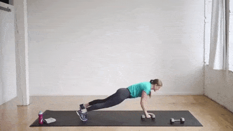 woman performing a push up and single arm row with dumbbell 