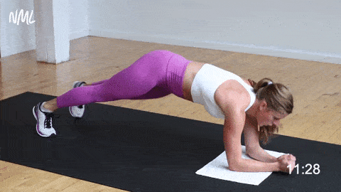woman performing a rolling low plank and back fly
