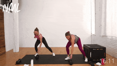 two women, one pregnant, performing a side shuffle and dumbbell tapdown
