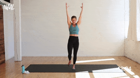 woman performing a single leg deadlift and balancing mountain pose to airplane pose as part of 30 minute yoga workout