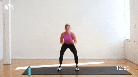 woman performing a squat and inner heel tap