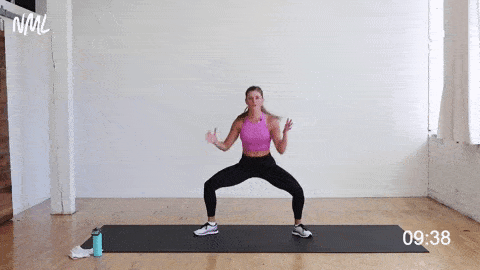 woman performing a sumo squat and lunge