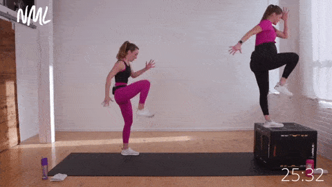 two women performing a box step up and knee drive. 