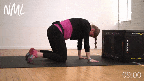 woman performing cat and cow stretch for sciatica