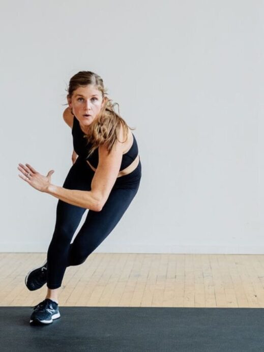 Woman performing a lateral bound in this HIIT leg workout, no equipment.