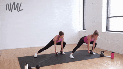 two women performing a lateral lunge to bicep curl with kettlebell 