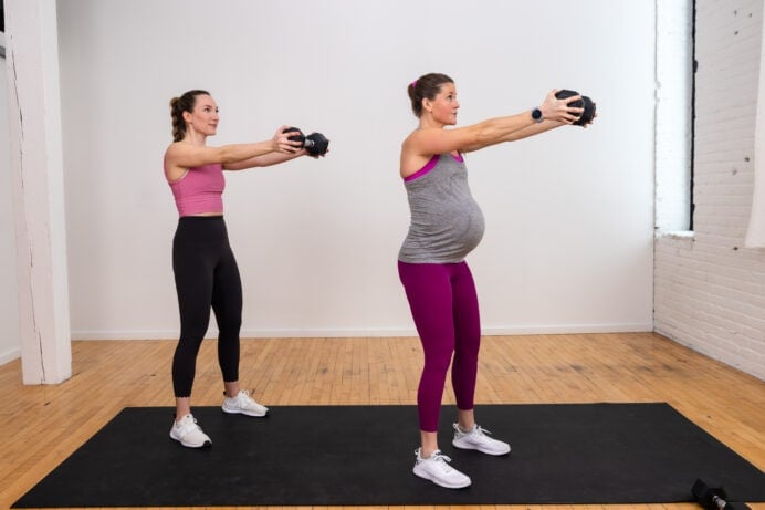 two women performing a dumbbell front raise